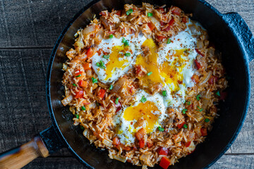 Boiled rice with fried eggs, red peppers, tomato and onions, closeup, Ukraine. Food background. Healthy food