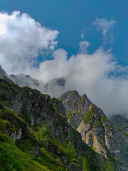 Fototapeta na wymiar Мountain peaks in the clouds