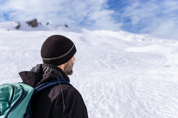 Man in rear view hiking in amazing alpine winter mountains landscape. Haehlekopf, Berlingerskoepfle, Vorarlberg, Austria. - 574792726