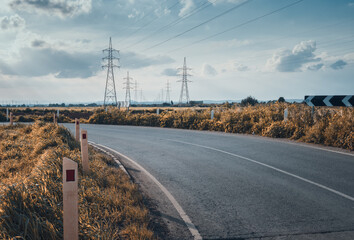 Road leading to electric towers with a moody cinematic look 
