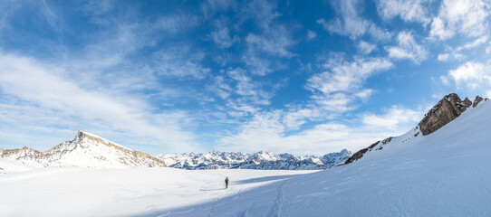 Man is snowshoe hiking in amazing alpine winter mountains landscape. Ifen, Haehlekopf, Vorarlberg, Austria. - 574793733