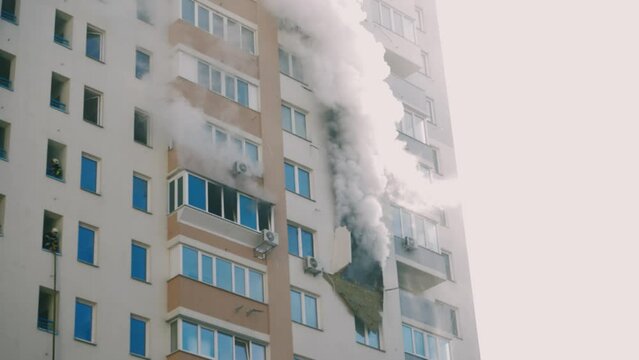 Kyiv, Ukraine - November 15, 2022: A group of firefighters stands on the balcony of an apartment building discussing a plan of action. Putting out a fire in an apartment building.
