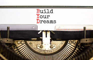 BYD build your dreams symbol. Concept words BYD build your dreams typed on retro old typewriter on a beautiful white paper background. Business and BYD build your dreams concept. Copy space.