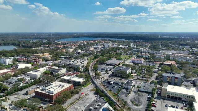 Aerial video of downtown Winter Park, Florida. USA February 22, 2023. Train in motion. 