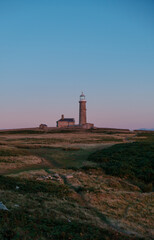 Fototapeta na wymiar Lighthouse at Sunset By the Sea