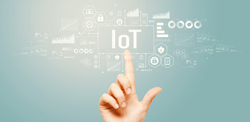 IoT theme with hand pressing a button on a technology screen