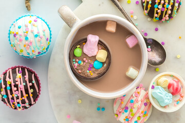 A look into a mug of hot cocoa with a hot cocoa bomb filled with confections.