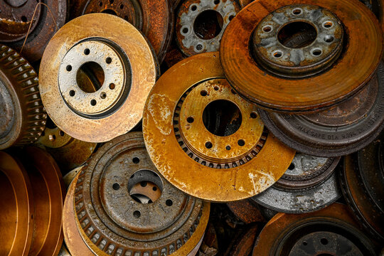 old brake rotors piled up at scrap yard 