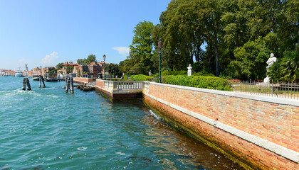 View of the Grand Canal on a hot summer morning. Blue sky, azure water, beautiful architecture of Venice, Italy