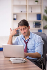 Young male employee working in the office