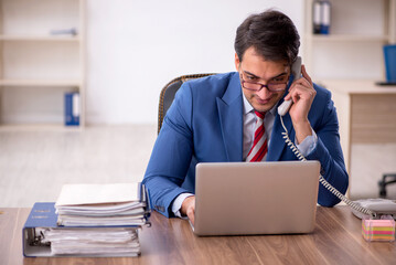 Young male employee working in the office