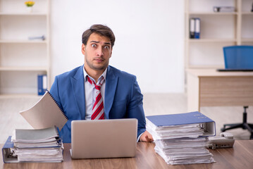 Young male employee working in the office