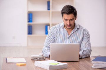 Young male employee working in the office