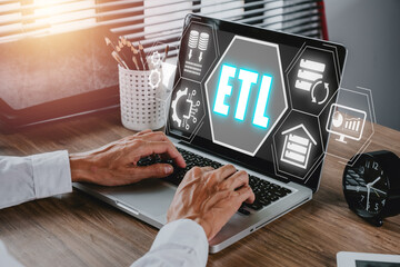ETL extract transform load concept, Person using laptop with extract transform load icon on virtual screen.
