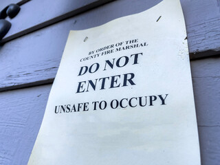 Close up view of a Do Not Enter sign outside a condemned house