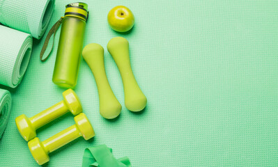 green fitness background.green fitness equipment on green background for background banner