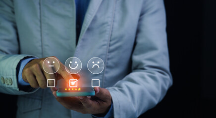 Customer satisfaction concept. Hands of a business man using a smartphone to comment 5 stars. Excellent business rating experience. Satisfaction Rating, good and impressive