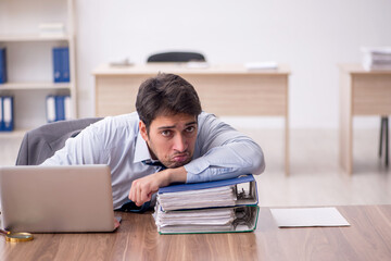 Fototapeta premium Young male employee working in the office