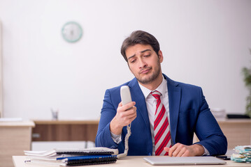 Young male employee working in the office