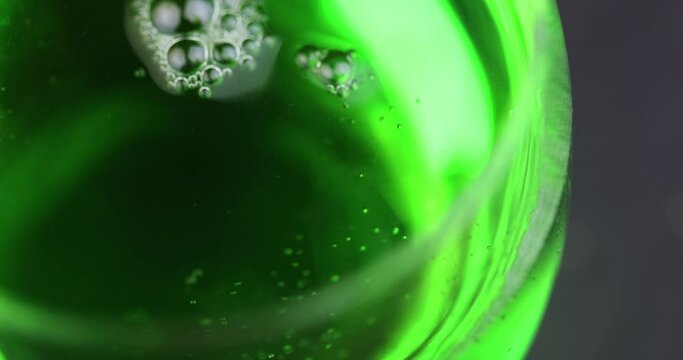 Green carbonated drink with gas on the table, green carbonated drink in a glass transparent glass