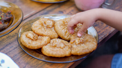 Kue Kucur or cucur is a traditional snack in Southeast Asia.
