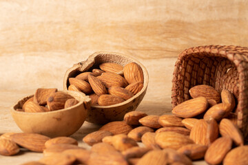 Shelled almonds in rustic containers. Amate paper background.