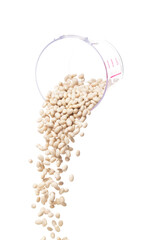 White bean fall down pour from measured cup, white bean float explode, abstract cloud fly. Off-white beans splash throwing in Air. White background Isolated high speed shutter, freeze motion