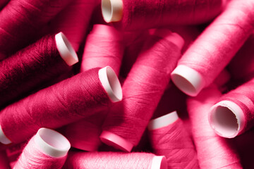 Heap of viva magenta sewing threads, closeup