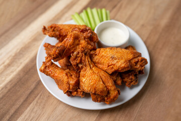 Buffalo chicken wings with celery and dip