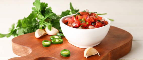 Bowl of tasty Pico de Gallo salsa on white table