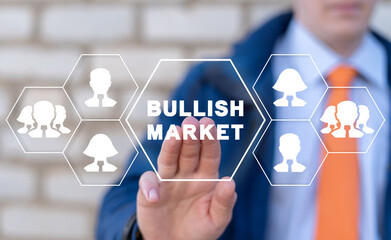 Trader working on virtual touch screen of future and sees inscription: BULLISH MARKET. Concept of bullish stock marketing. Financial investment. Bull market.