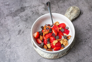 Yogurt and fruit in a bowl. Greek yogurt with fruit and nuts, healthy diet friendly dessert. 