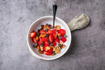 Yogurt and fruit in a bowl. Greek yogurt with fruit and nuts, healthy diet friendly dessert. 