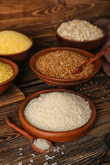 Plate with rice on wooden background