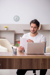 Young male employee working from home during pandemic