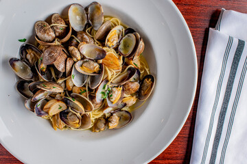 Seafood Pasta with clams. Pasta with clams, seafood, Parmesan cheese, spinach, and Italian parsley. Classic American or Italian restaurant favorite. Homemade pasta, tomato sauce, meats and cheeses.