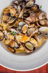 Seafood Pasta with clams. Pasta with clams, seafood, Parmesan cheese, spinach, and Italian parsley. Classic American or Italian restaurant favorite. Homemade pasta, tomato sauce, meats and cheeses.