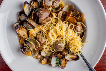 Seafood Pasta with clams. Pasta with clams, seafood, Parmesan cheese, spinach, and Italian parsley. Classic American or Italian restaurant favorite. Homemade pasta, tomato sauce, meats and cheeses.