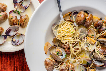 Seafood Pasta with clams. Pasta with clams, seafood, Parmesan cheese, spinach, and Italian parsley. Classic American or Italian restaurant favorite. Homemade pasta, tomato sauce, meats and cheeses.
