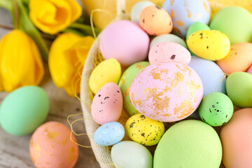 Fototapeta na wymiar Basket with beautiful Easter eggs, closeup