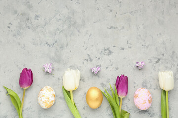 Composition with beautiful spring flowers and Easter eggs on grunge background