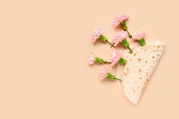 Creative composition with tortilla and carnation flowers on color background