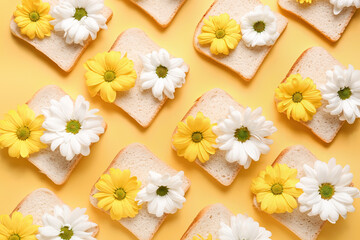 Composition with slices of bread and beautiful chrysanthemum flowers on yellow background