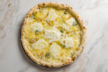 Pizza Quattro formaggi on white marble table top view