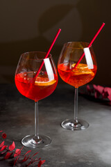 cocktail aperol spritz on glass on grey table vertical