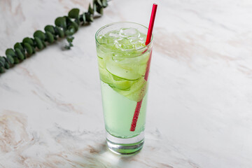 cucumber lemonade in glass on marble table
