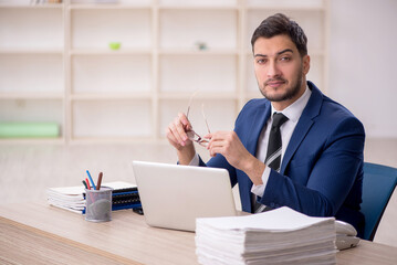 Young male employee working in the office