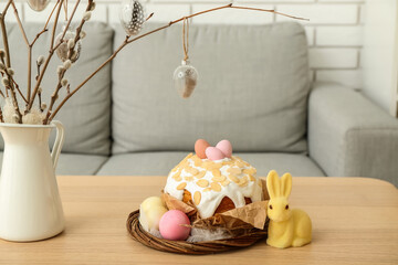 Easter cake, painted eggs and bunny on table in living room