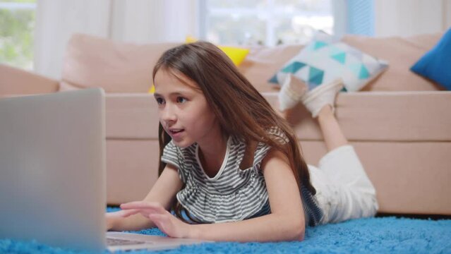 Preteen child use computer surfing internet play game at home. 
