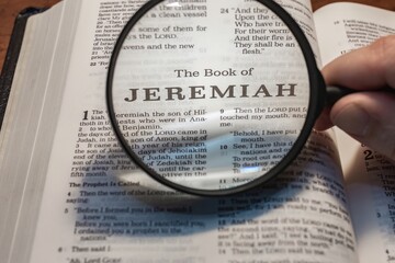 title page book of Jeremiah close up using magnifying glass in the bible or Torah for faith,...